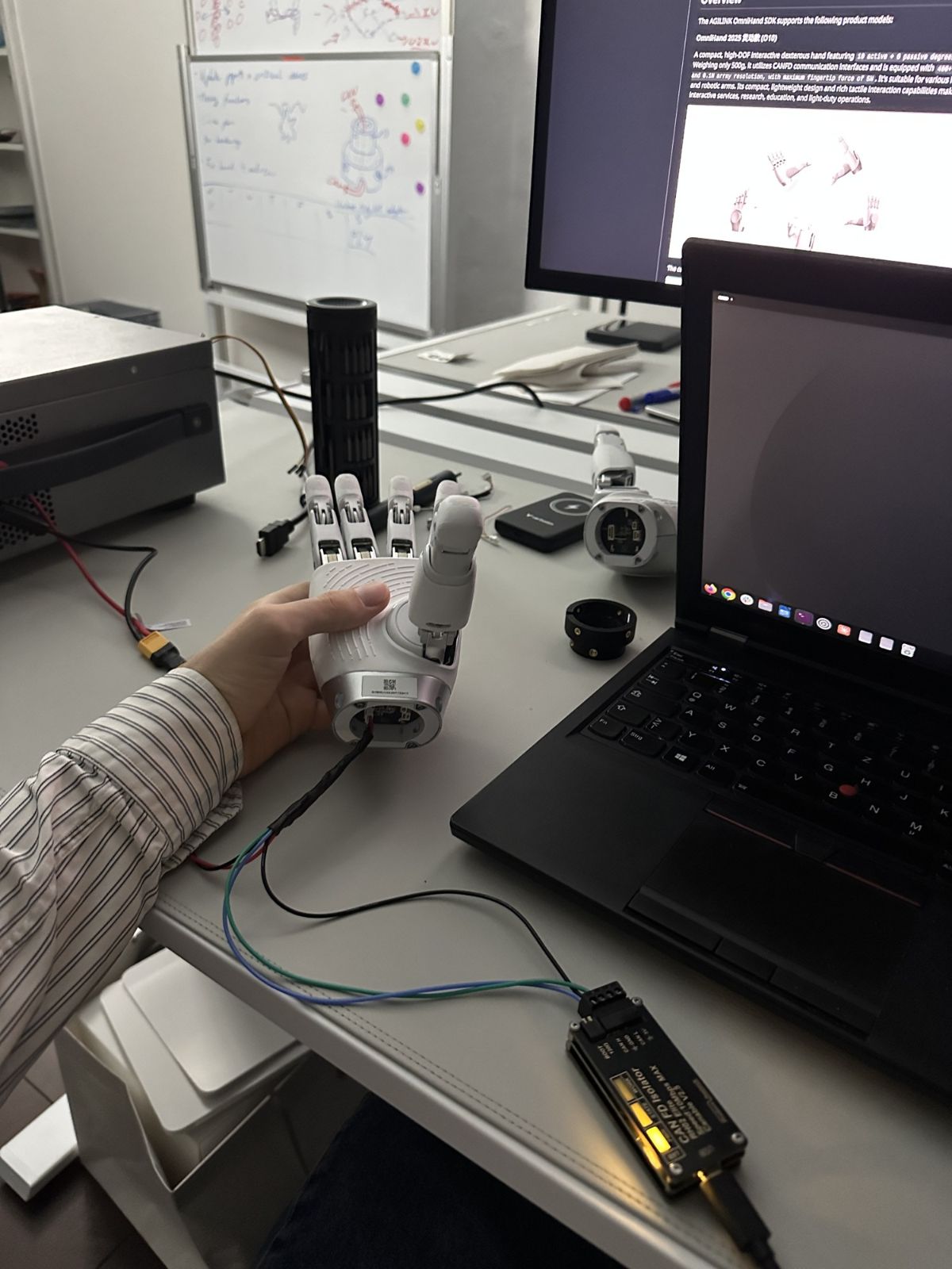 The OmniHand O10 during bring-up after repair, on the CAN FD isolator.